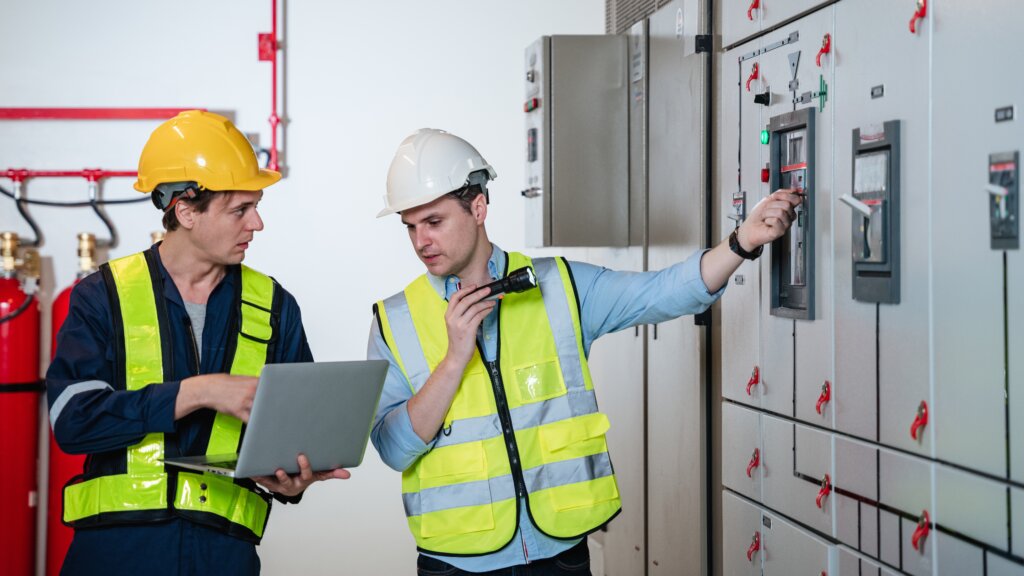 Authorities Having Jurisdiction (AHJs) inspecting an electrical panel.