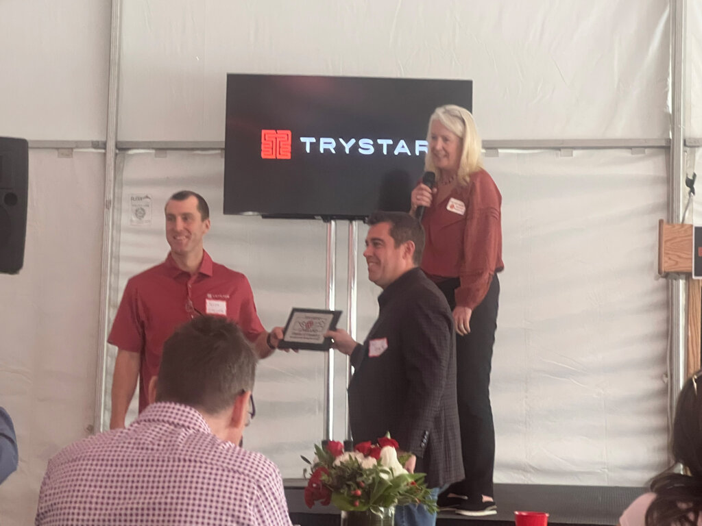 Trystar's Loveland, Colorado grand opening, receiving a plaque from the Loveland Chamber of Commerce.
